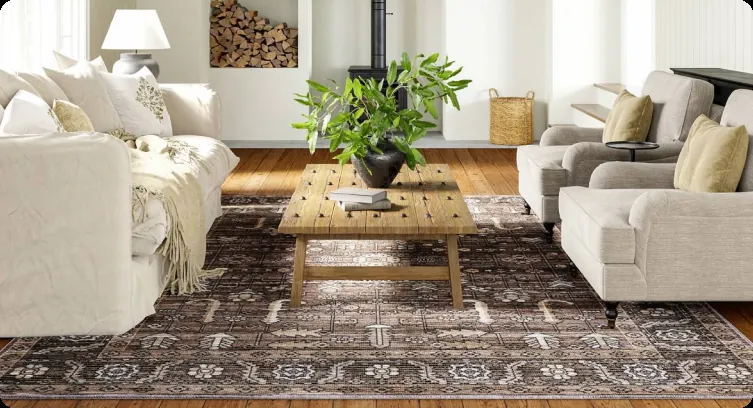 A patterned carpet under a wooden coffee table between two sofas