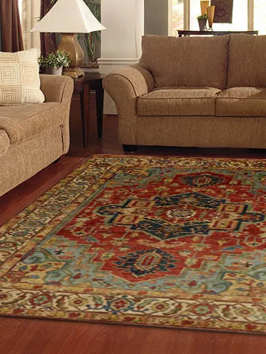 A red and blue oriental carpet between two sofas